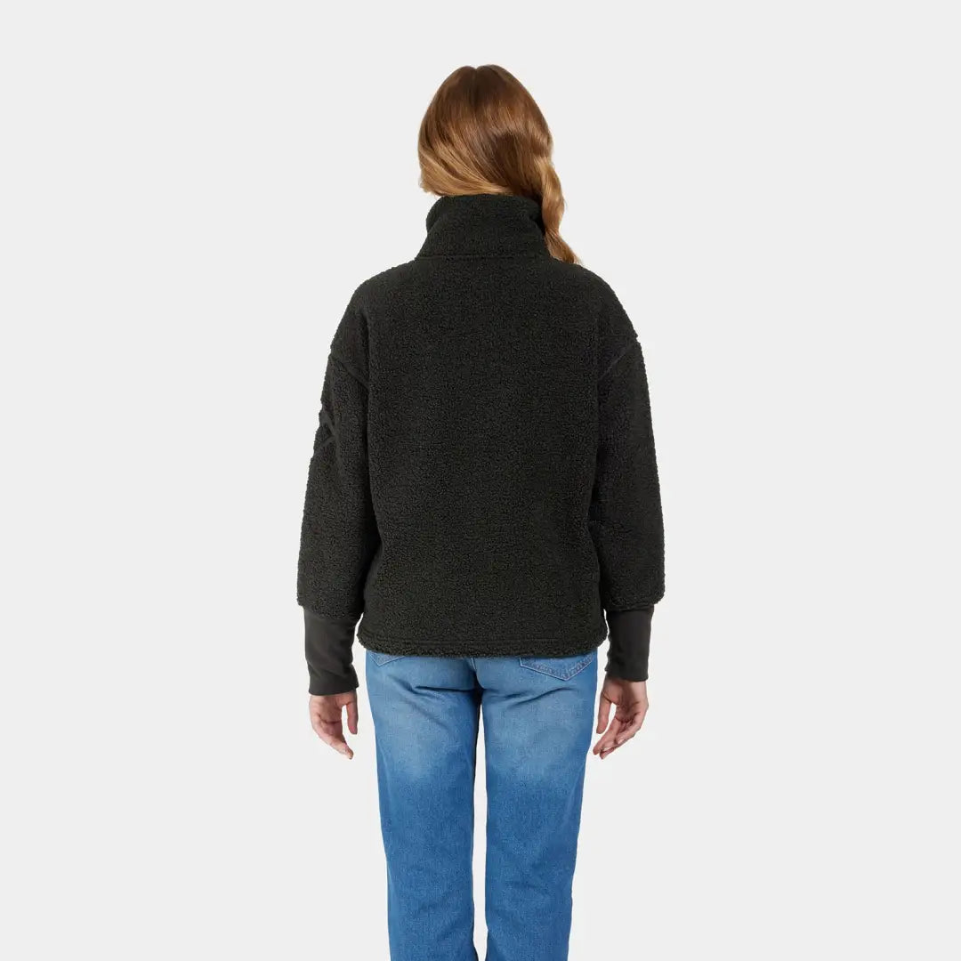 Black turtleneck sweater perfect for autumn’s crisp winds, worn by a person with long hair