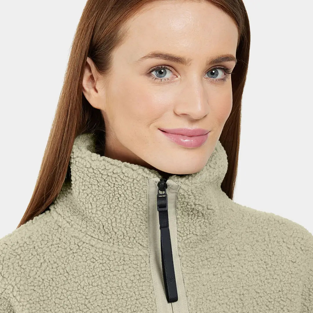 Woman in a light green fleece jacket ready to tackle chilly autumn winds