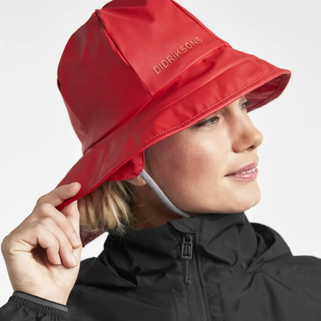 Bright red Didriksons Southwester Waterproof Rain Hat with logo for rainy days