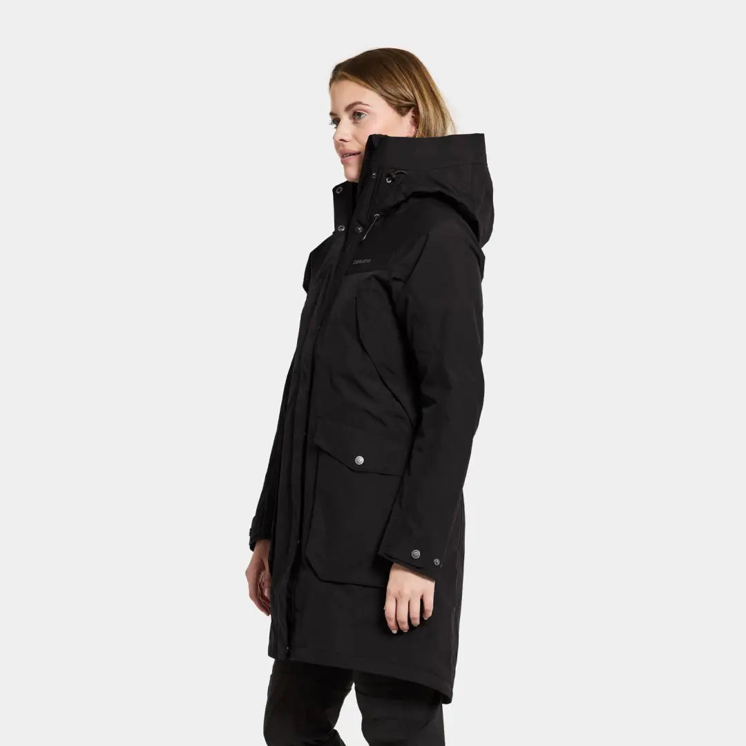 Black hooded winter coat worn by a woman showcasing iconic Didriksons style and warmth