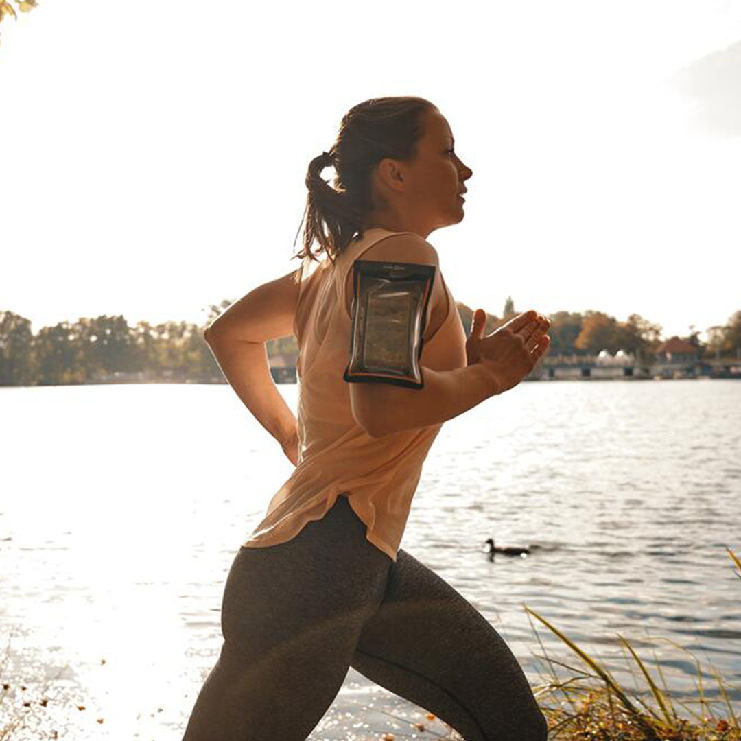 Woman jogging with Fidlock Armband Dry Bag, keeping phone safe and dry