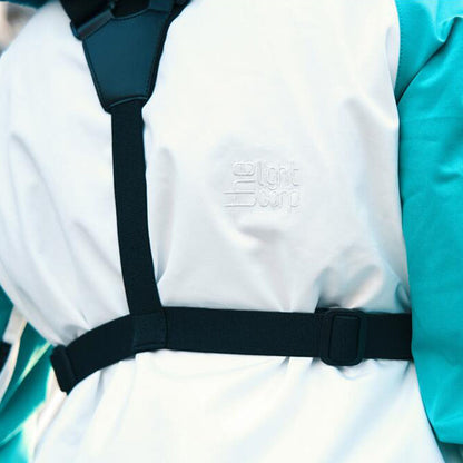 White jacket with black straps on Fidlock Chest Dry Bag, a stylish hermetic chest bag