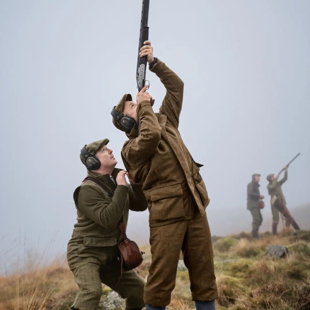 Two people in military uniforms showcasing the Kenmore GTX Jacket’s traditional look