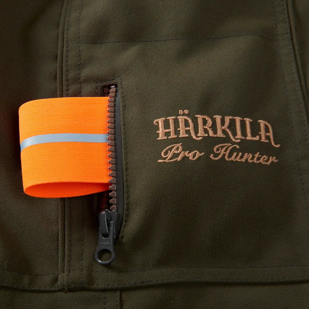 Olive green Harkila Pro Hunter Endure Jacket with orange safety band and logo