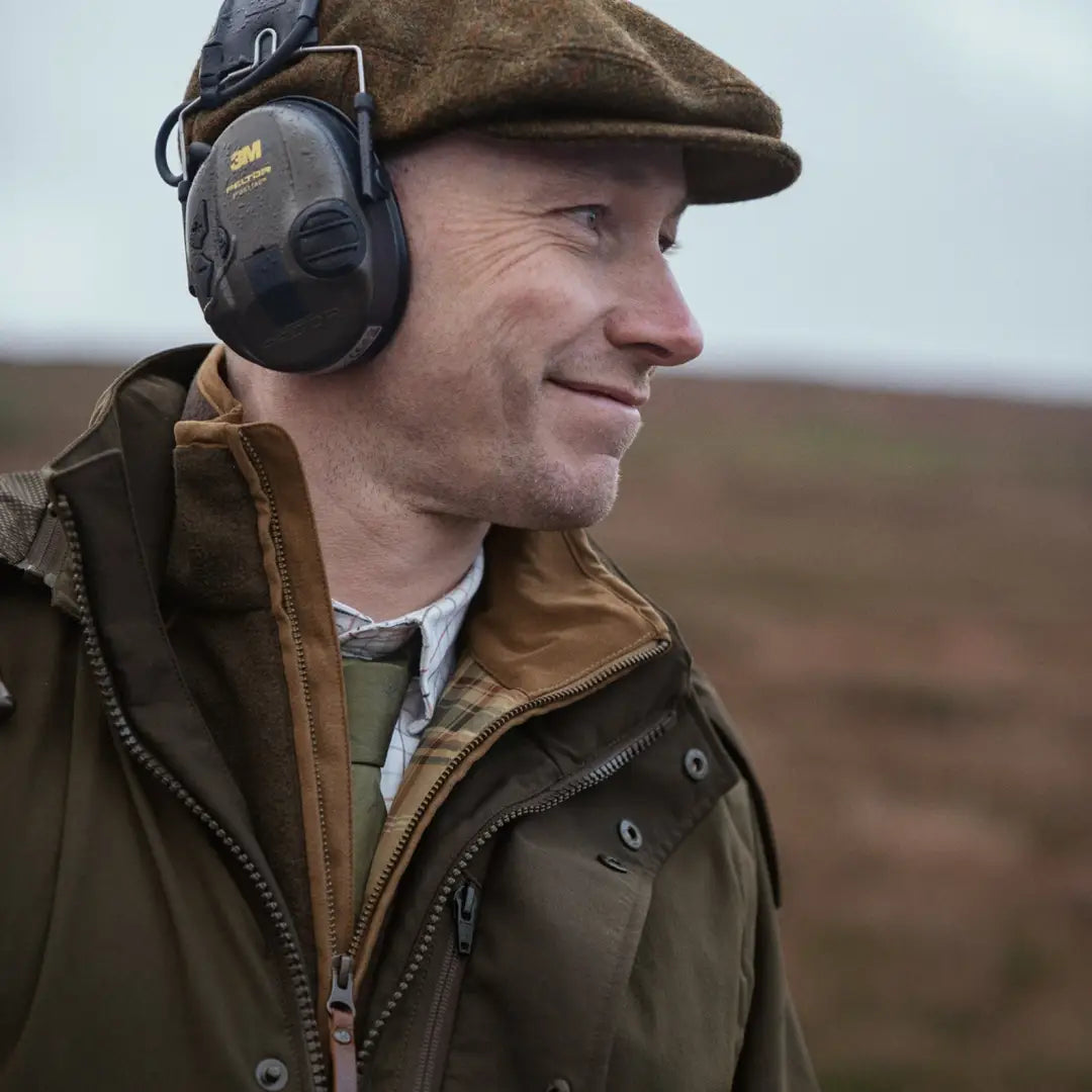 Man in flat cap and ear muffs rocking the Harkila Pro Hunter Shooting GTX Jacket