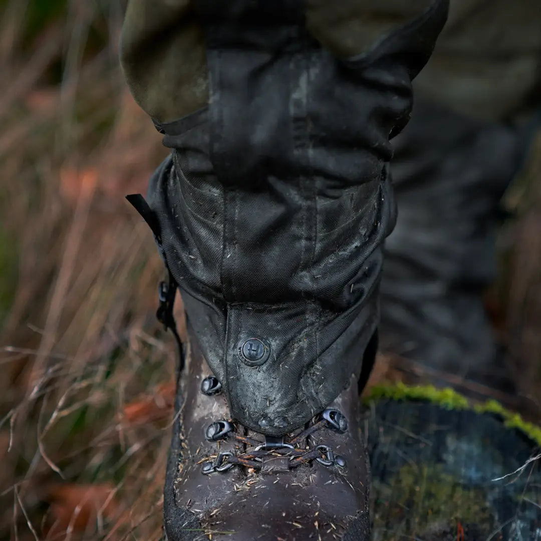 Rugged leather hiking boot with laces in outdoor setting near Harkila Pro HWS Gaiters