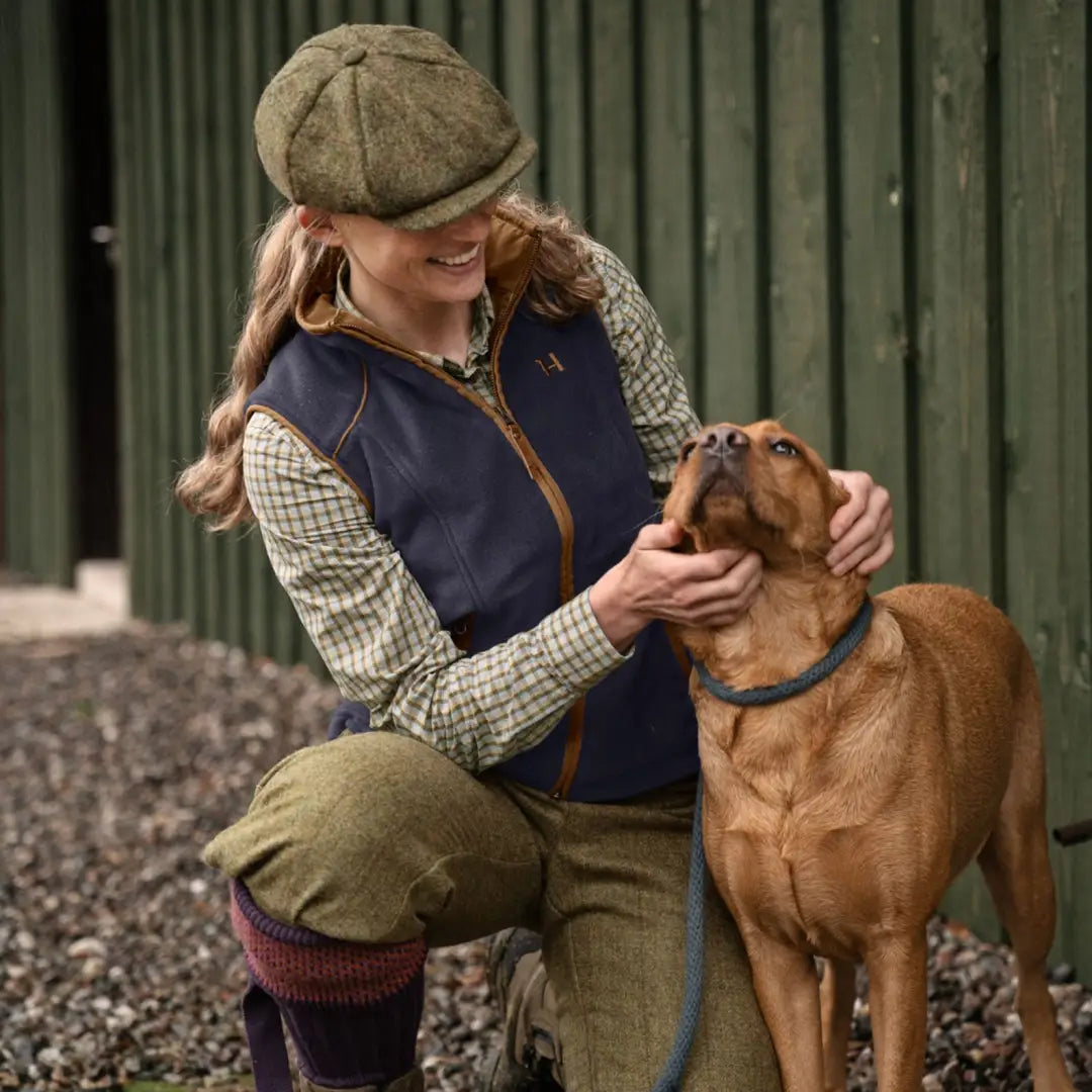 Brown dog with blue collar being petted in Harkila Sandhem 200 Waistcoat, stylish look