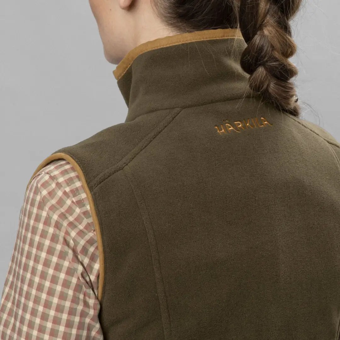 Stylish Olive Green quilted vest with gold trim, perfect for embracing the female figure