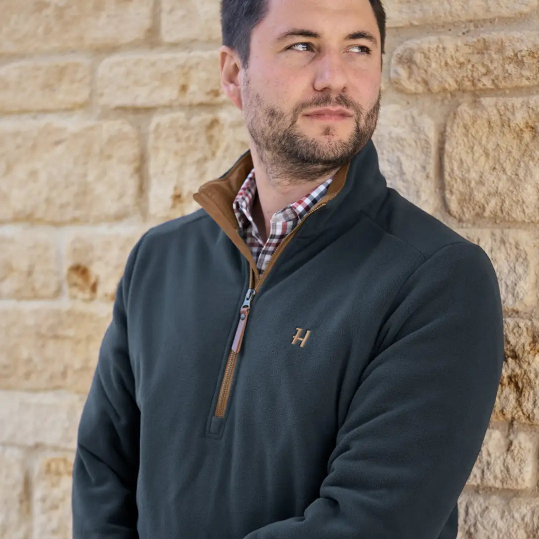 Man in a Harkila Sandhem pullover and plaid shirt, perfect for country clothing and hunting