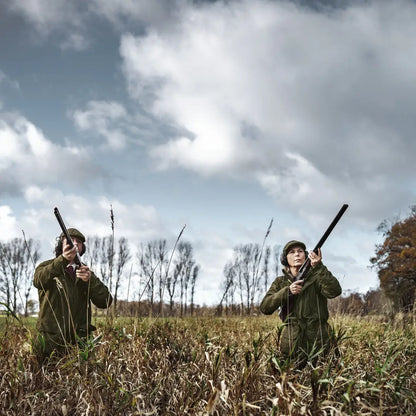 Two hunters in a field showcasing the Stornoway Shooting Lady Jacket