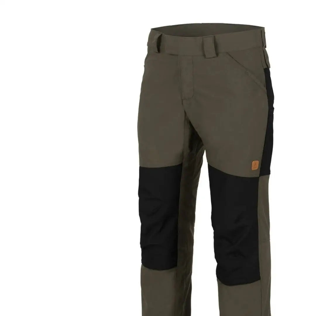 Olive green Helikon-Tex Woodsman Pants with durable black knee patches for outdoor enthusiasts