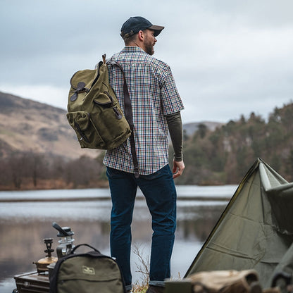 Olive green canvas backpack next to Hoggs Of Fife Aberdour short sleeve checked shirt