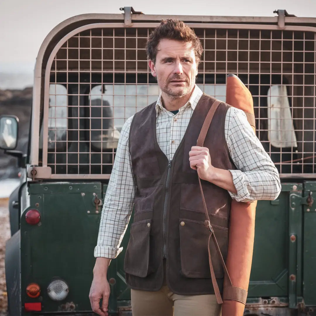 Man in country-style gear with a green vehicle, showcasing Fife Balmoral Luxury Tattersall Shirt