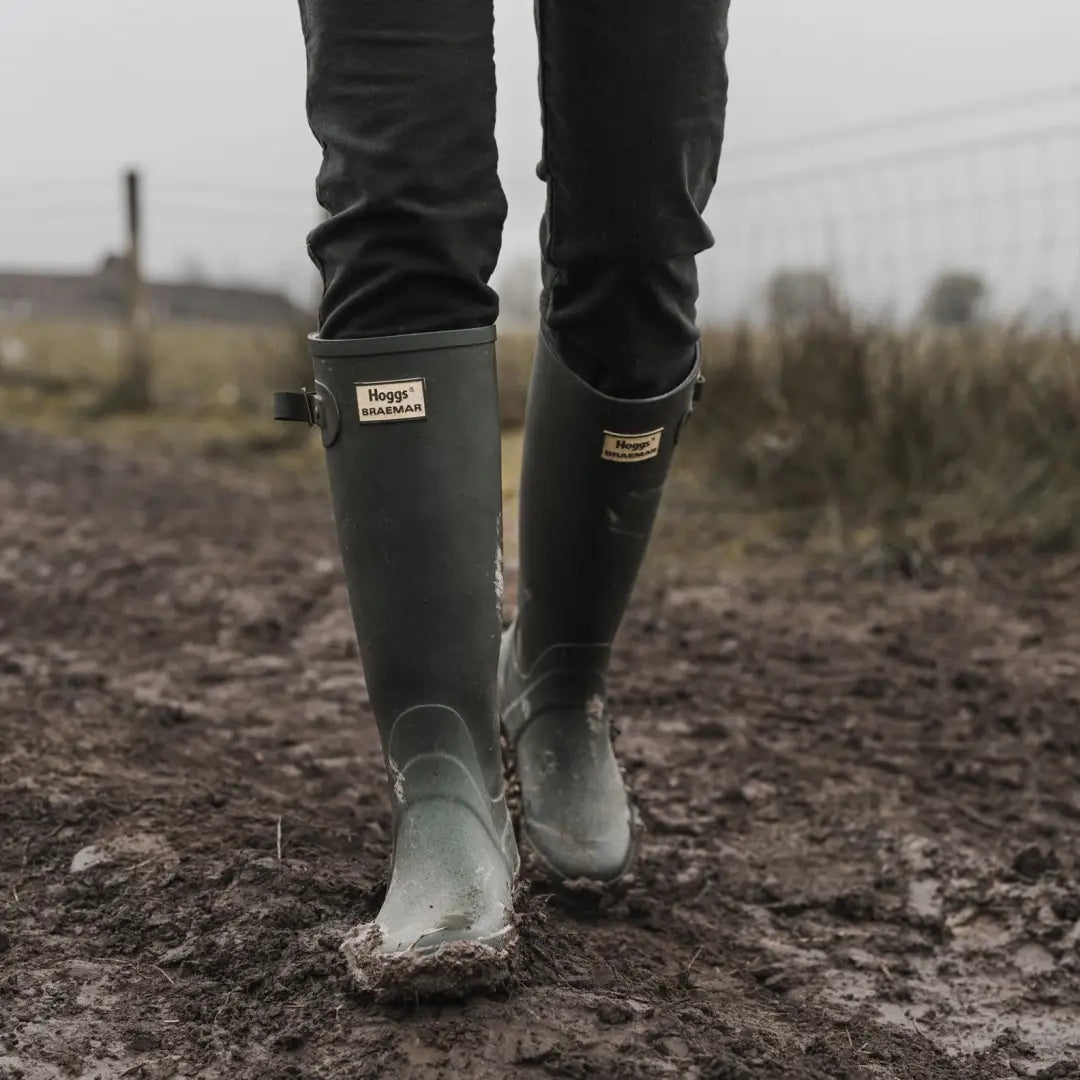 Green Hoggs Of Fife Braemar Wellington Boots on muddy ground, ideal for outdoor adventures