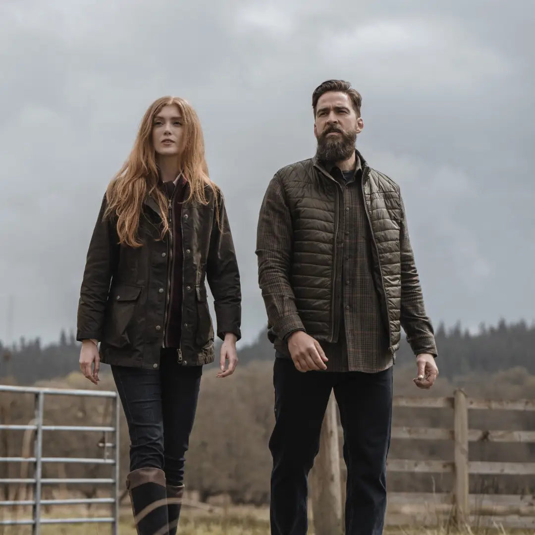 Two people wearing casual winter clothes in a Fife Caledonia Ladies Wax Jacket