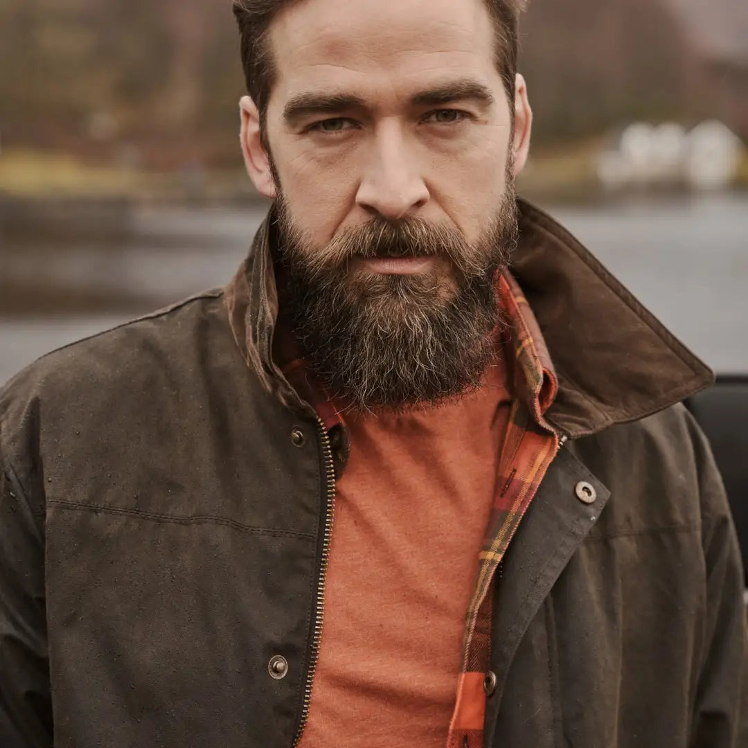 Man with a full beard in brown jacket showcasing Hoggs of Fife’s water resistant qualities