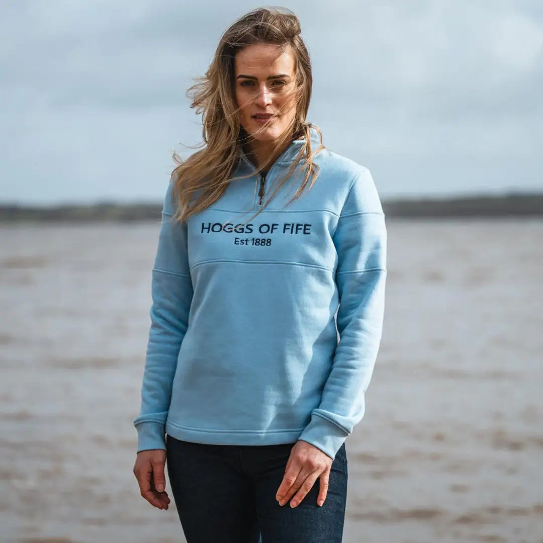 Light blue ladies quarter zip sweatshirt with HOGGS OF FIFE text on front