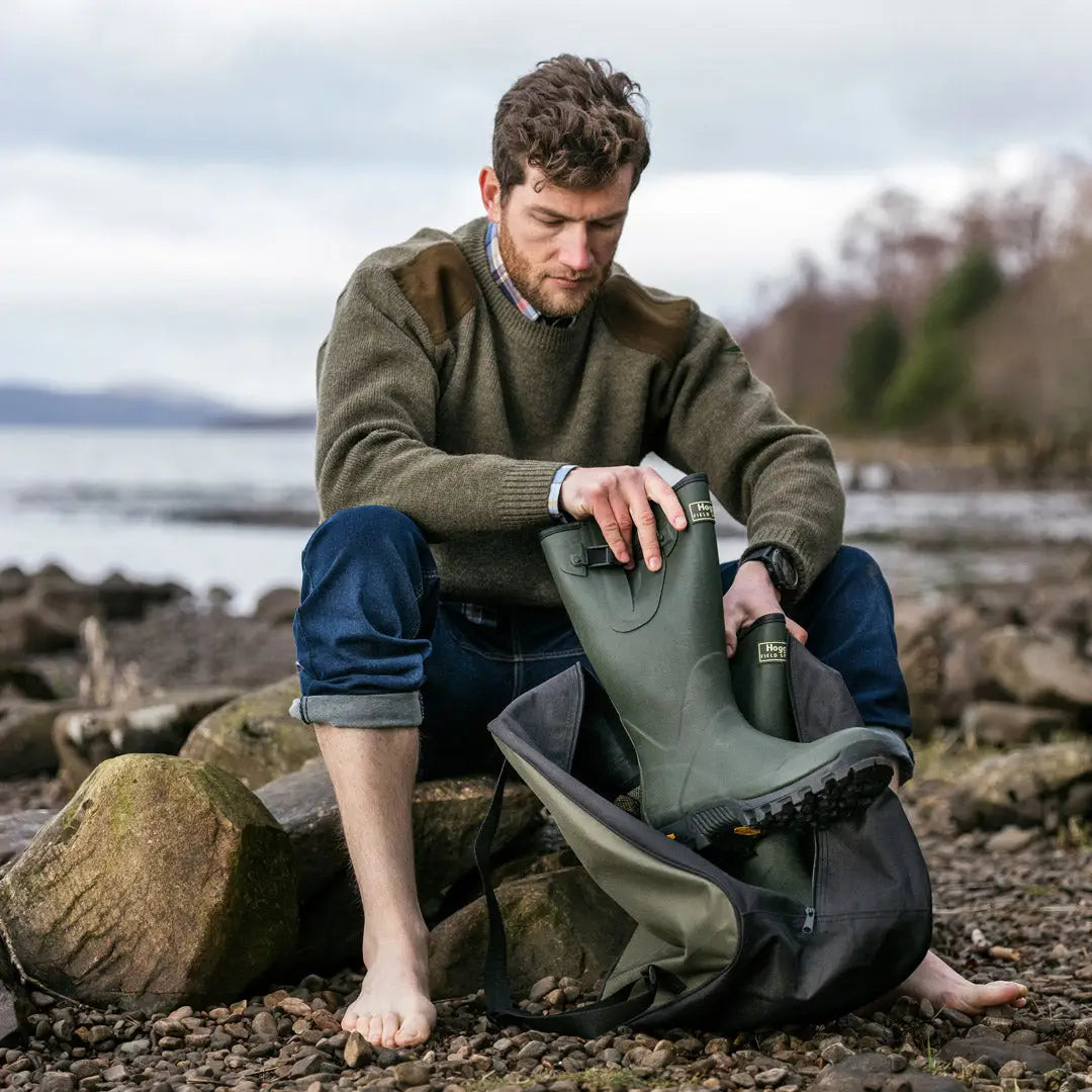 Man on rocky shore wearing Hoggs of Fife Field Sport Neoprene-lined Wellingtons