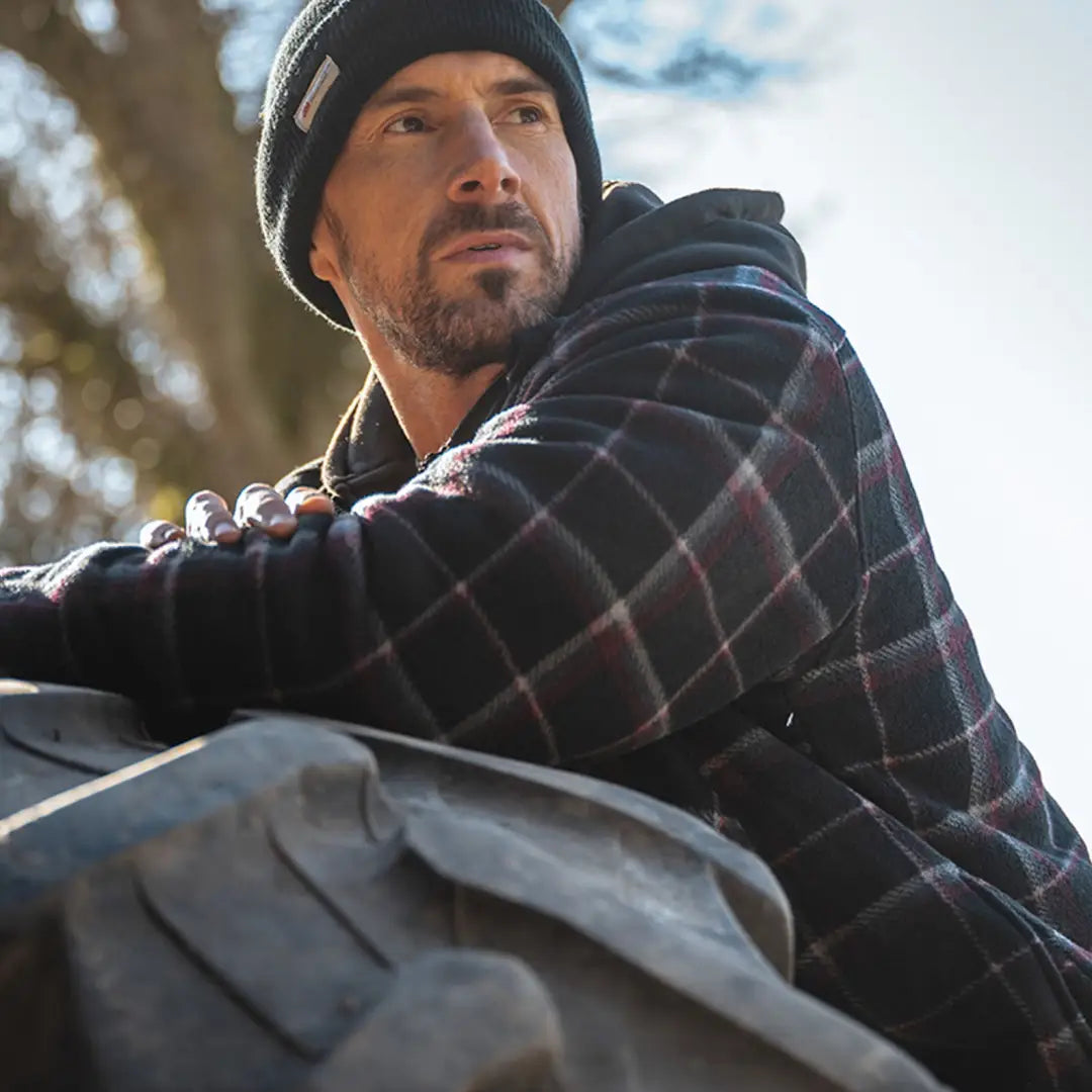 Man in plaid jacket and black beanie wearing Granite Hooded Work Fleece