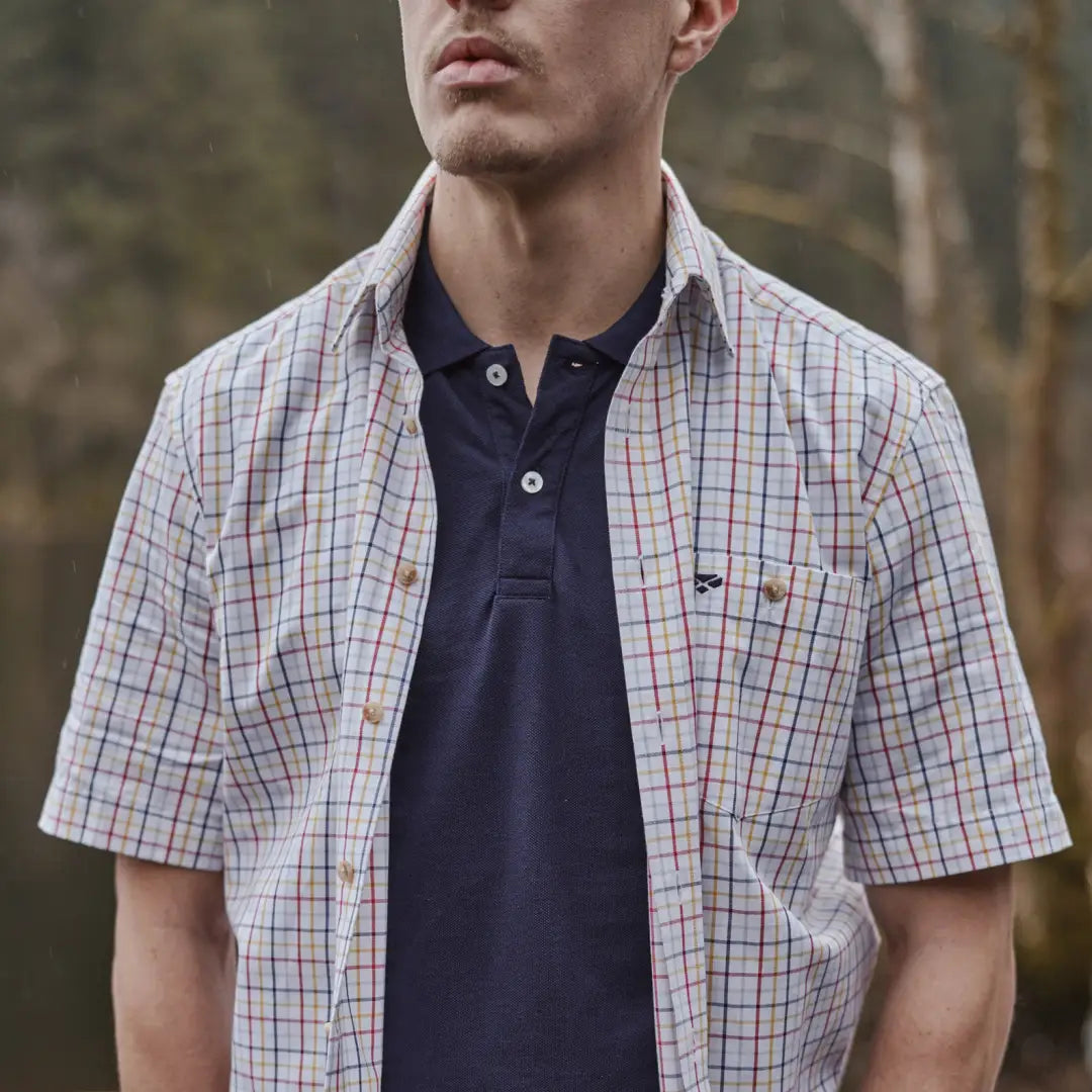 Short sleeve shirt in plaid worn over a navy polo, Kessock Tattersall style