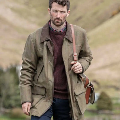 Bearded man in khaki jacket and burgundy sweater wearing a stylish lambswool field coat