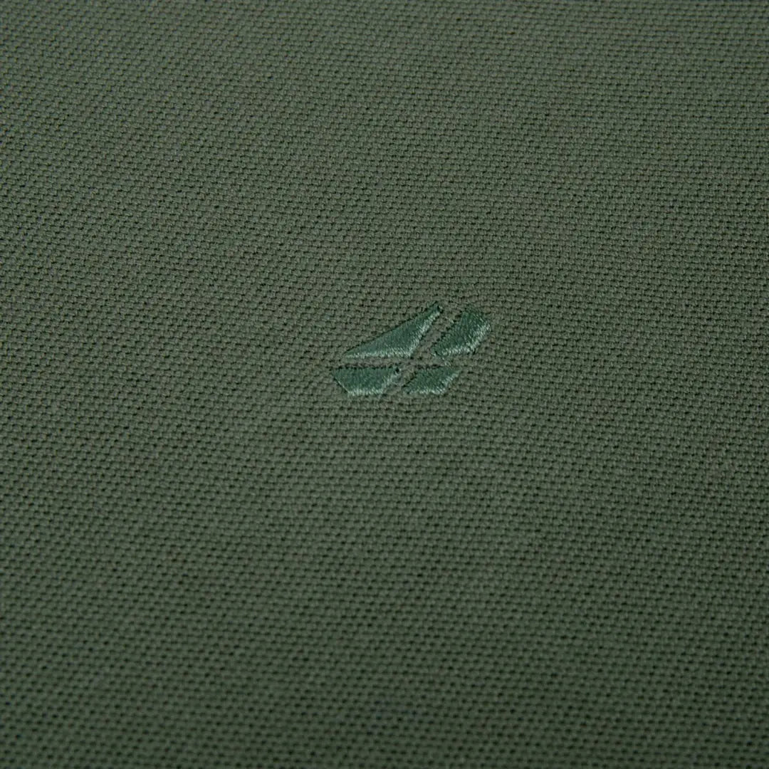 Green fabric featuring a small logo on the Hoggs Of Fife Largs Polo shirt