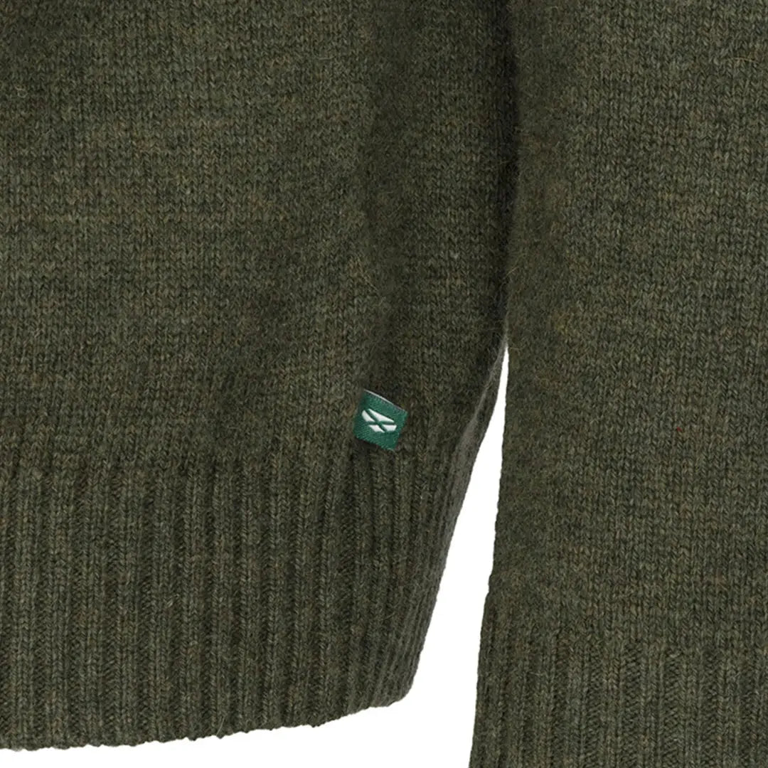 Dark green knitted Hoggs of Fife zip pullover with a teal button exudes style