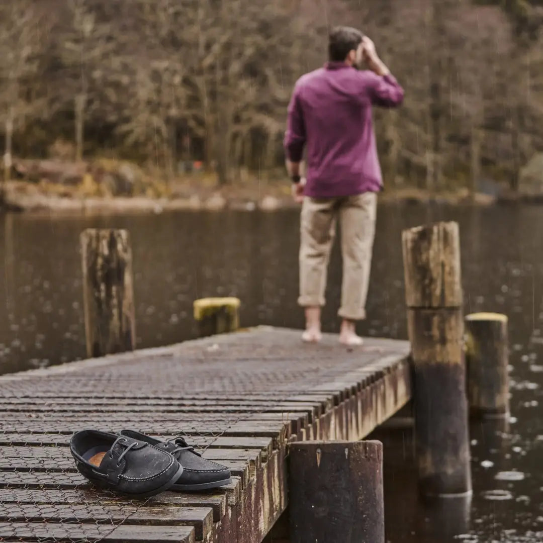 Person enjoying the lake while wearing Fife Mull Deck shoes on a wooden dock