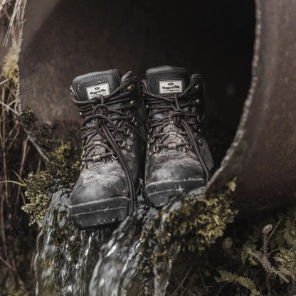 Worn black Hoggs Of Fife Munro Classic Waterproof Hiking Boots on mossy ground