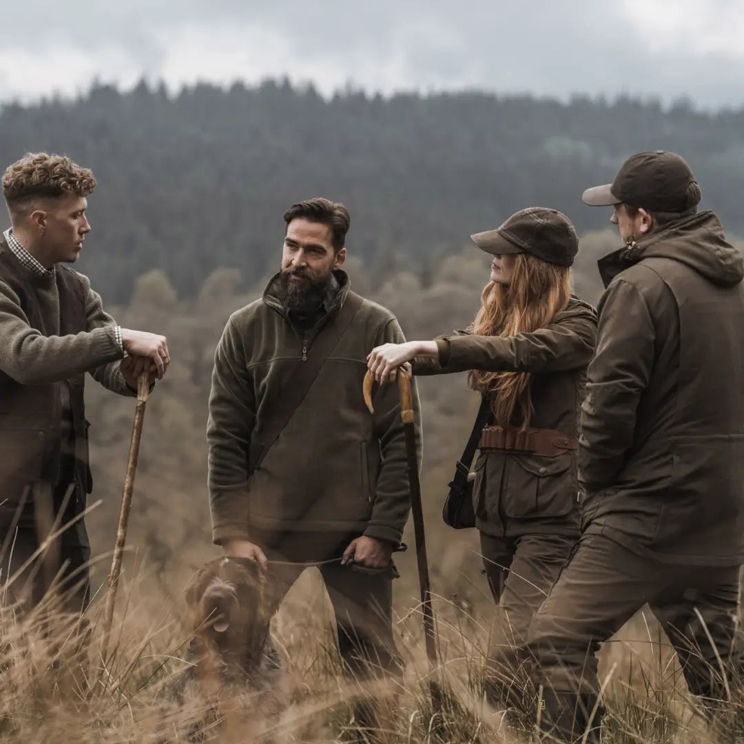 Group of friends in outdoor gear with a dog, featuring a ladies hunting jacket