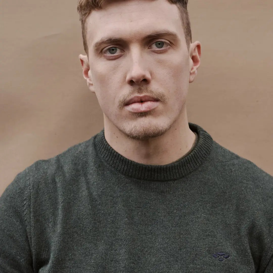 Man with short brown hair in a dark green Hoggs of Fife Stonehaven Crew Neck Pullover