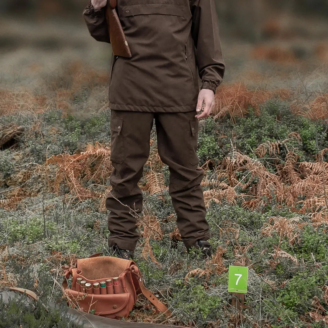 Person in brown hunting gear wearing Fife Struther field trousers in a field