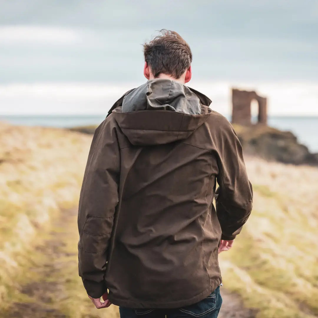 Person in a brown jacket showcasing the Fife Struther Waterproof Jacket from Hoggs Of Fife