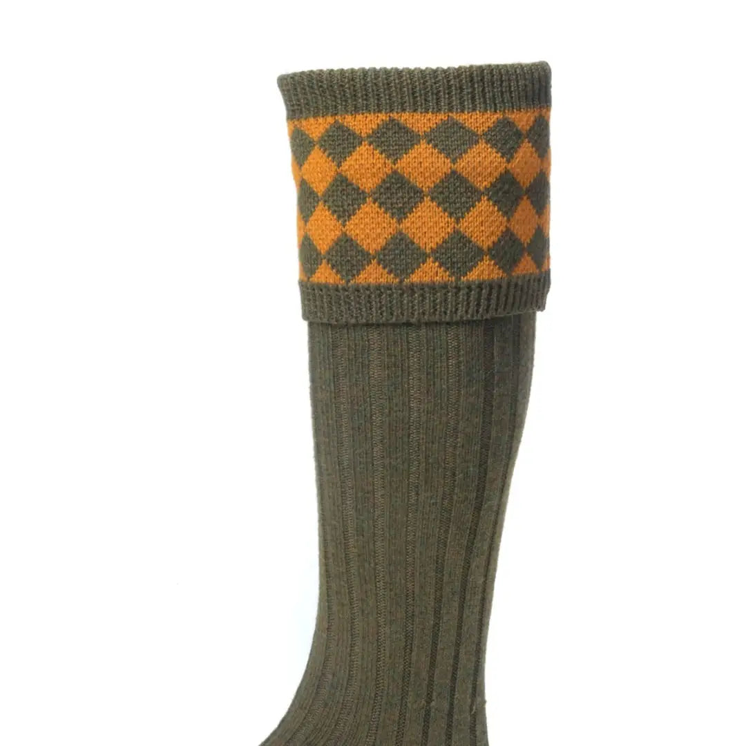 Olive green knee-high House of Cheviot Chessboard Socks in a merino wool blend with orange diamonds