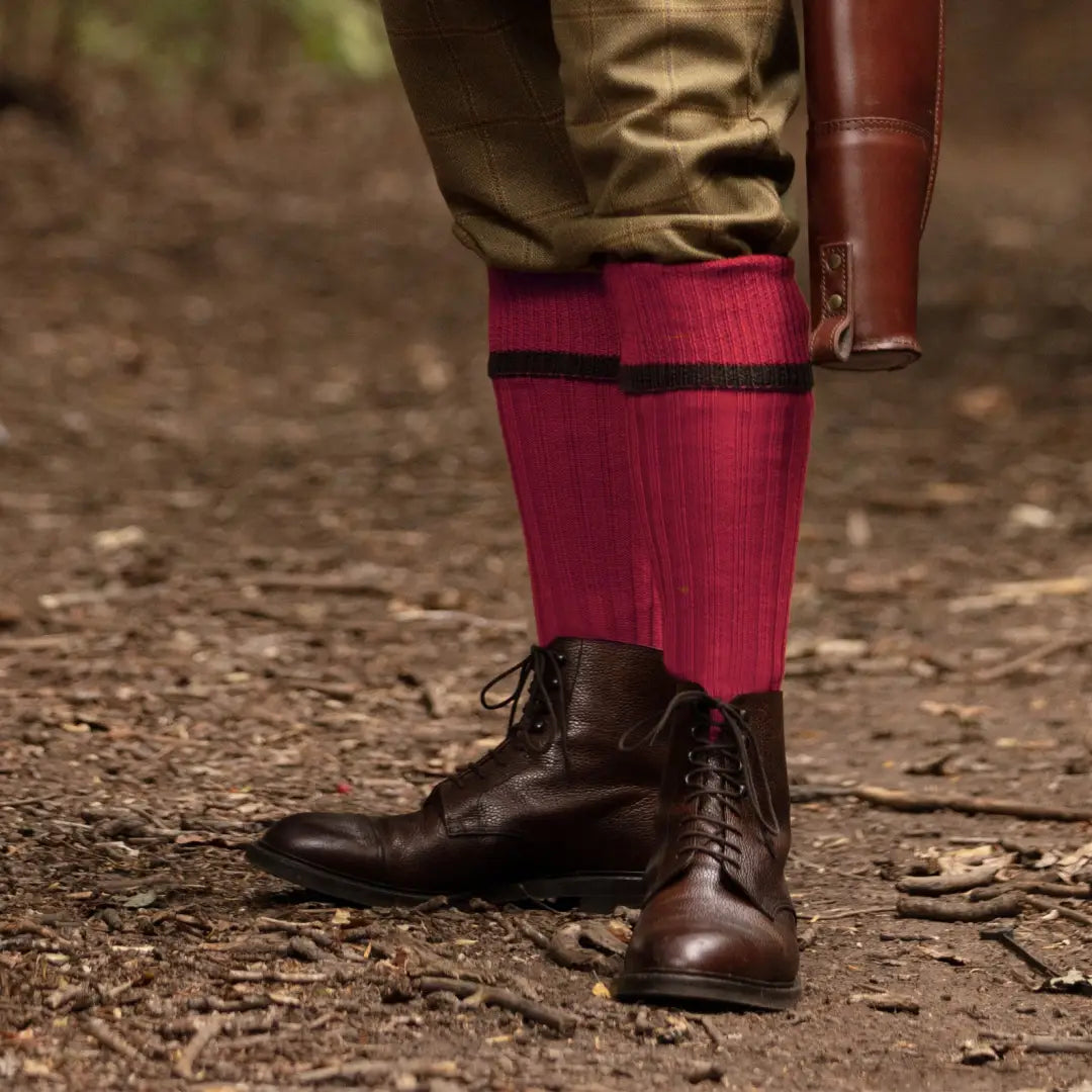 Dark brown leather boots with vibrant red House of Cheviot Estate Field Socks peeking out