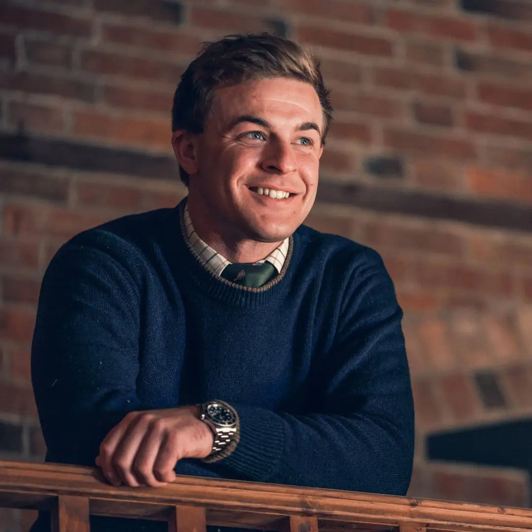 Smiling young man in navy sweater showcasing Jack Pyke Ashcombe Lambswool Pullover