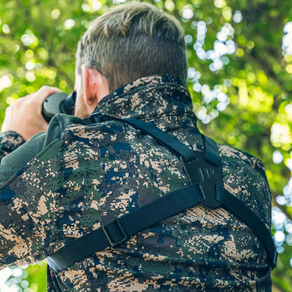 Digital camouflage jacket worn while using Jack Pyke binoculars with harness