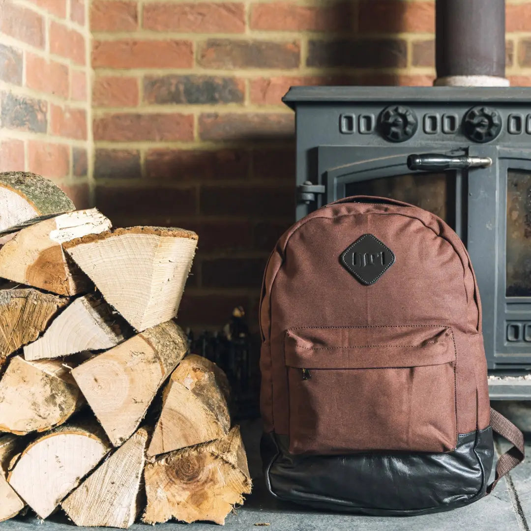 Brown Jack Pyke Canvas Backpack with black trim and front pocket for outdoor adventures