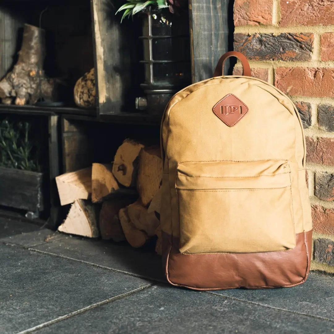 Beige Jack Pyke Canvas Backpack with brown leather bottom and red logo patch