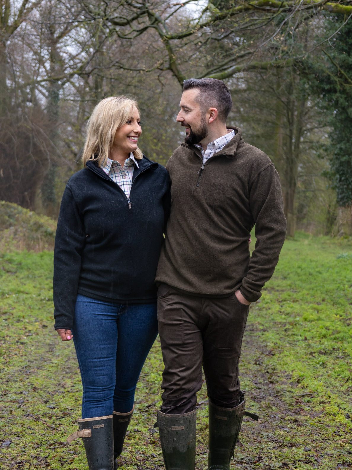 Couple in outdoor attire showcasing Jack Pyke Country Fleece Top for adventurous vibes