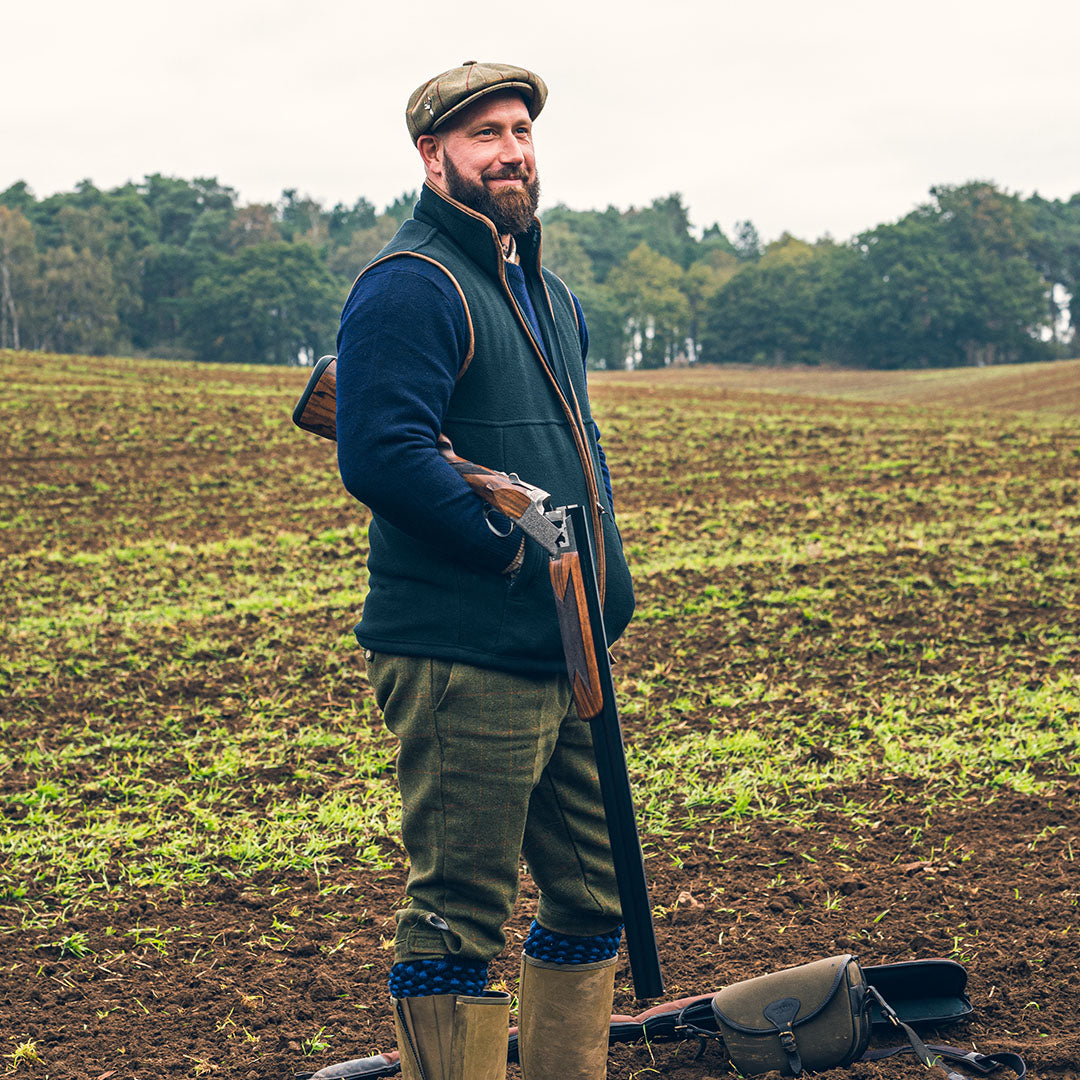 Hunter with shotgun wearing Jack Pyke Countryman Fleece Gilet in 300gsm micro fleece