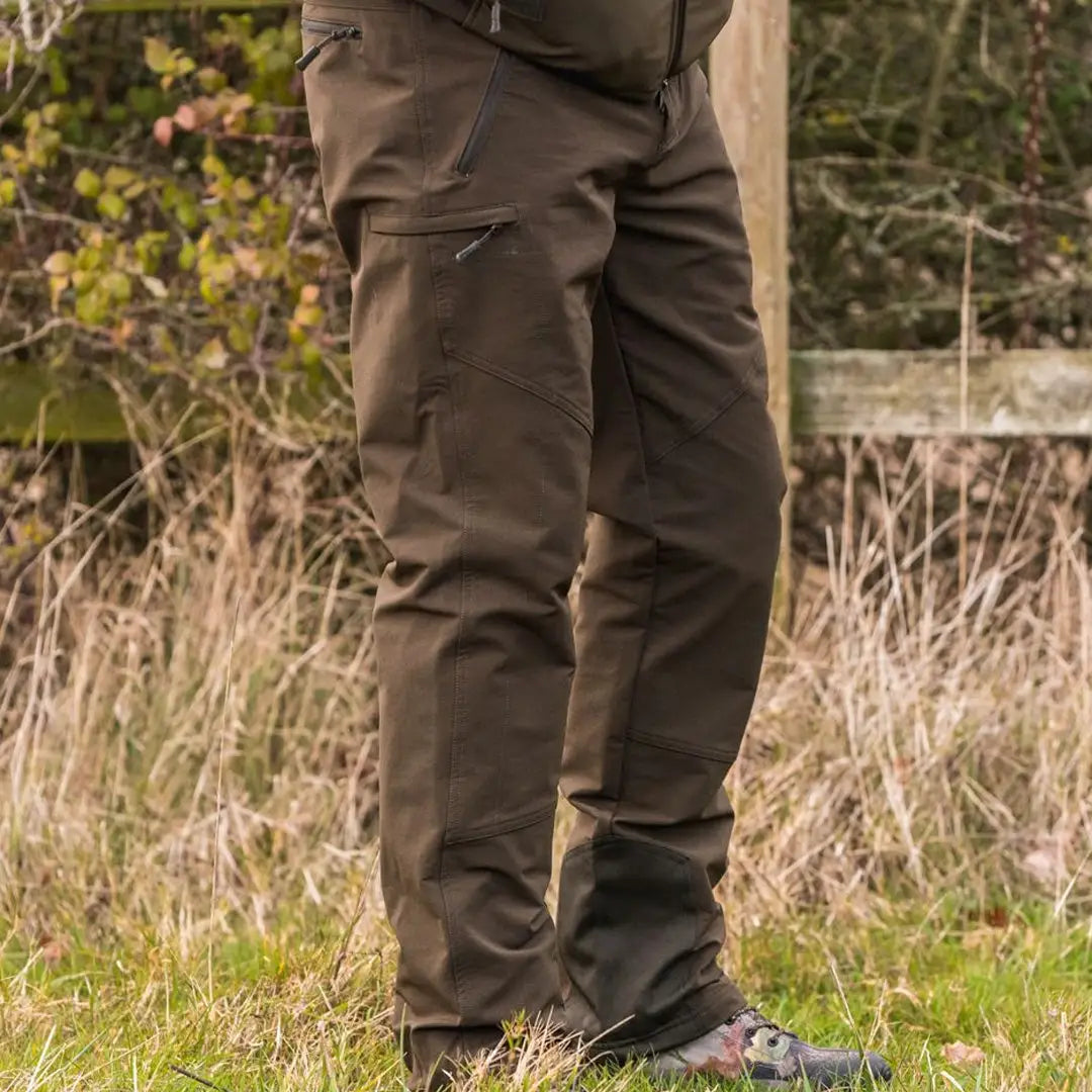 Person in brown Jack Pyke Dalesman Stretch Trousers standing in grassy outdoor setting