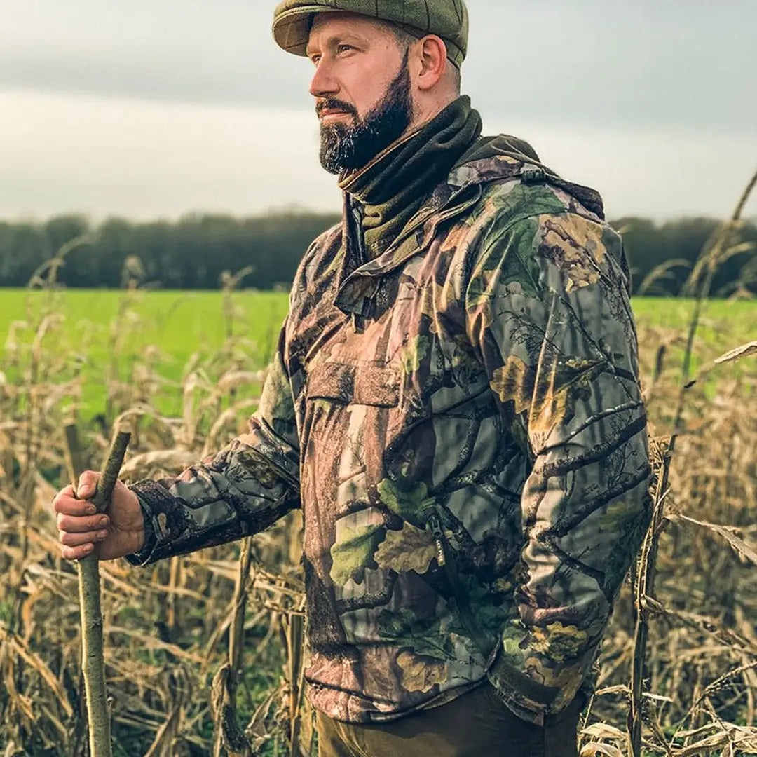 Bearded man in camouflage wearing the Jack Pyke Galbraith Smock in a field