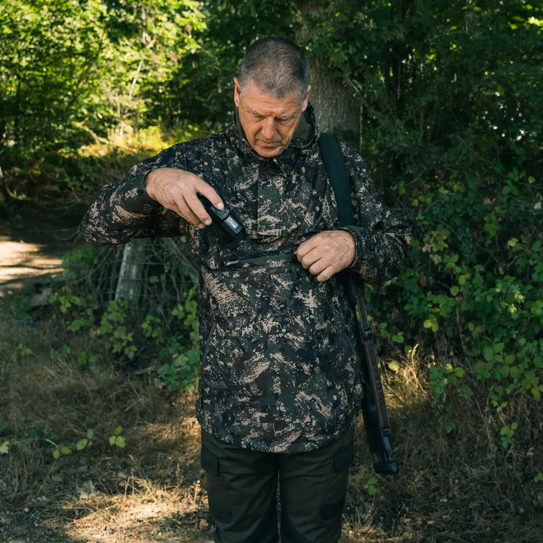 Camouflage jacket worn outdoors, showcasing Jack Pyke Galbraith Hunting Smock style