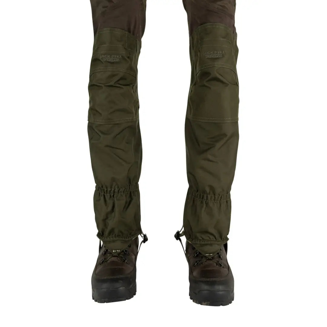 Olive green Jack Pyke Highline tactical pants with gaiters over brown hiking boots