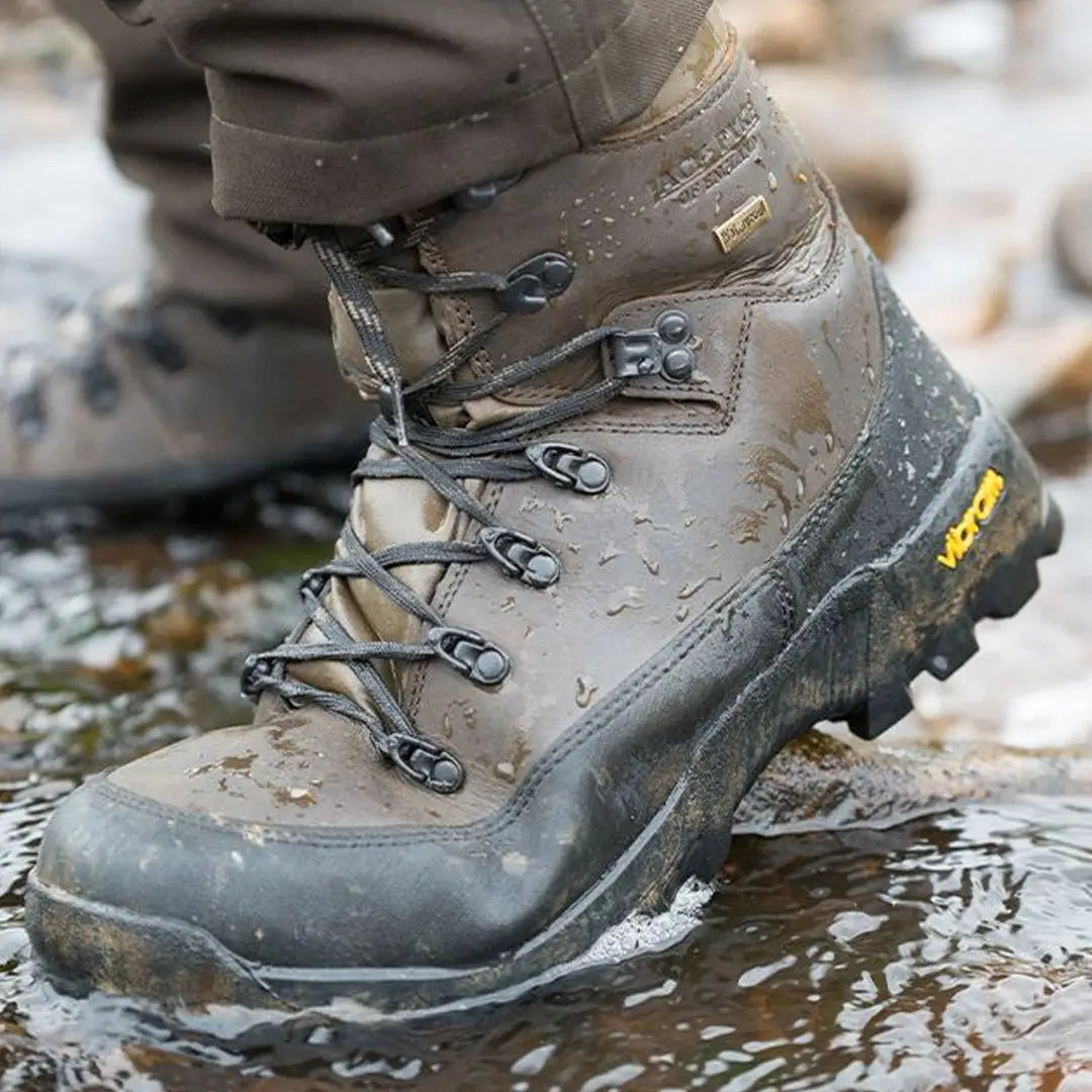 Rugged Jack Pyke Hunters Boots splashing in shallow water during a hike