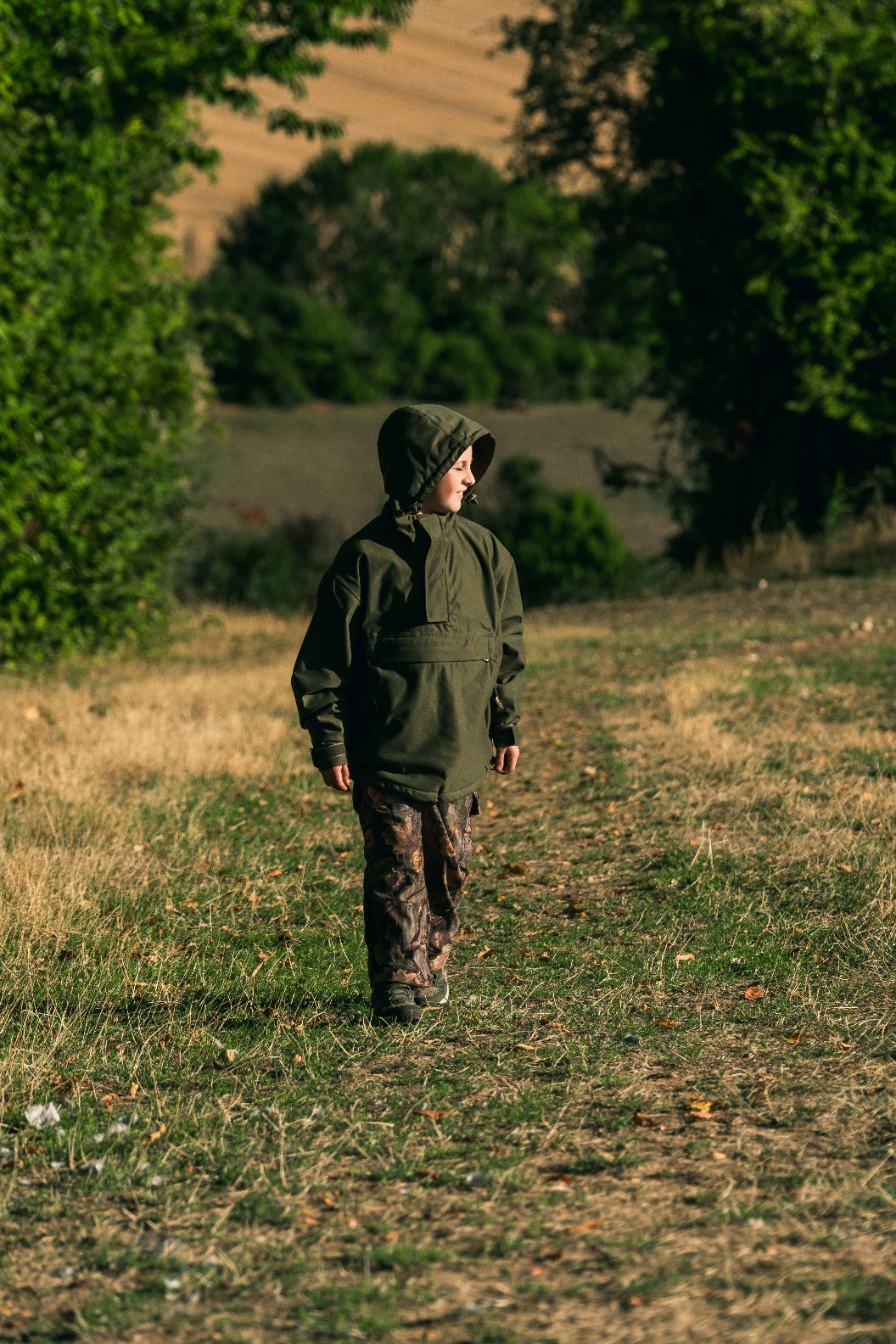 Camouflaged child in Jack Pyke Junior Galbraith Smock for outdoor adventures