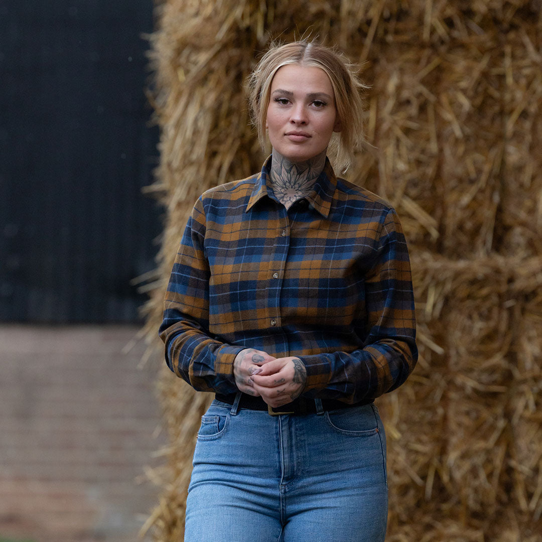 Tattooed woman rocking a Jack Pyke Ladies Bleasdale Heavy Flannel Shirt in plaid