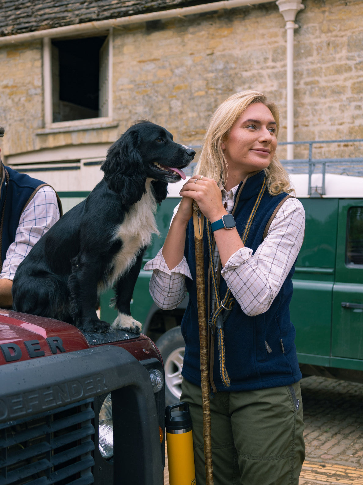 Woman in Jack Pyke Ladies Countryman Fleece Gilet with dog next to a Land Rover