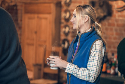 Woman enjoying a hot drink while wearing a Jack Pyke Ladies Countryman Fleece Gilet